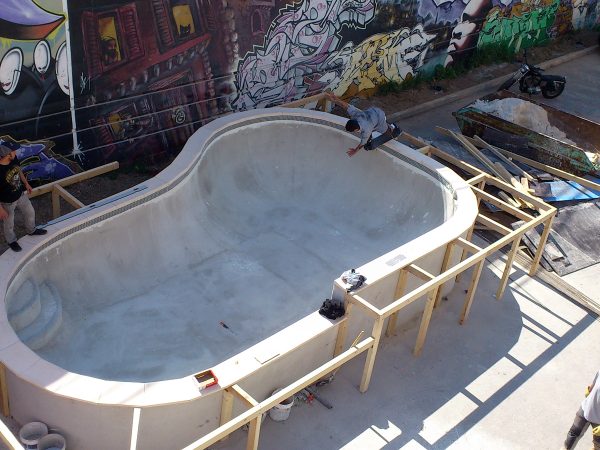 Julien Benoliel taking his first runs in the bowl he designed as the concrete is still drying. Backside disaster.