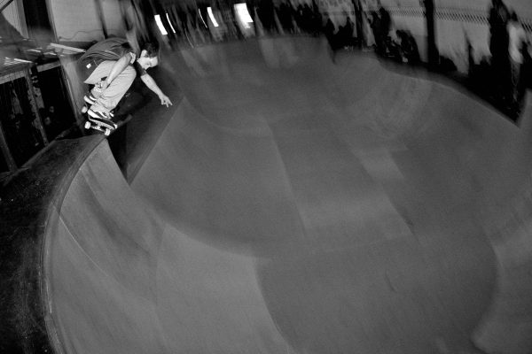 Alain Saavedra. Ollie up from the lower deck up over into the bowl. 